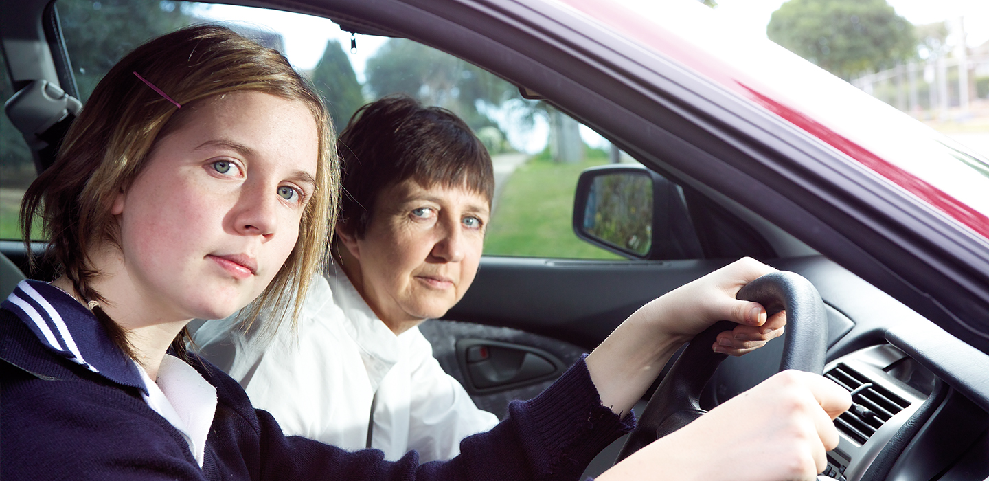 A learner driver and her mum sitting in the car