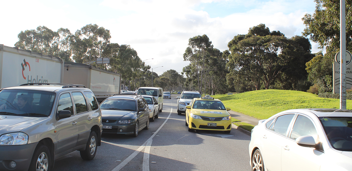 Lots of cars waiting in traffic on a highway