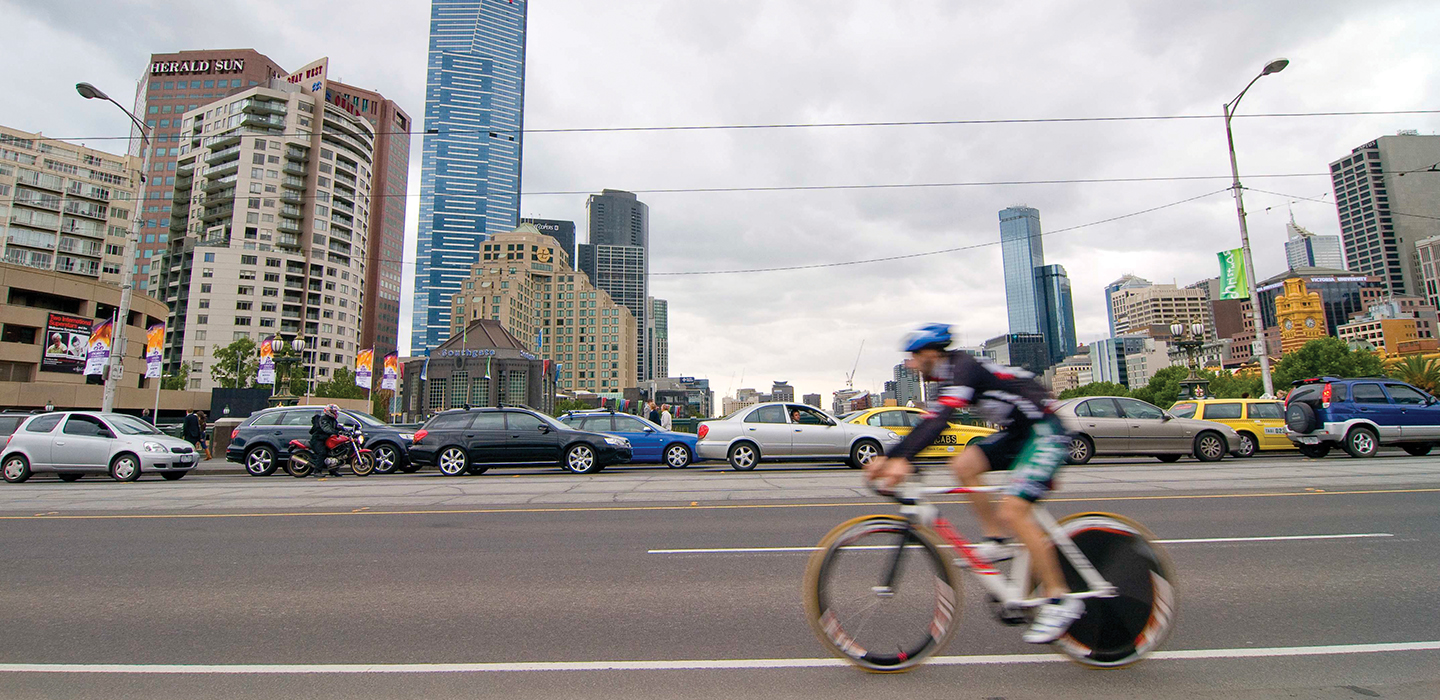 A bike rider cycling on the road in the city