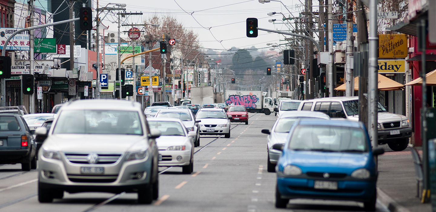 Lots of cars and traffic lights on a busy road