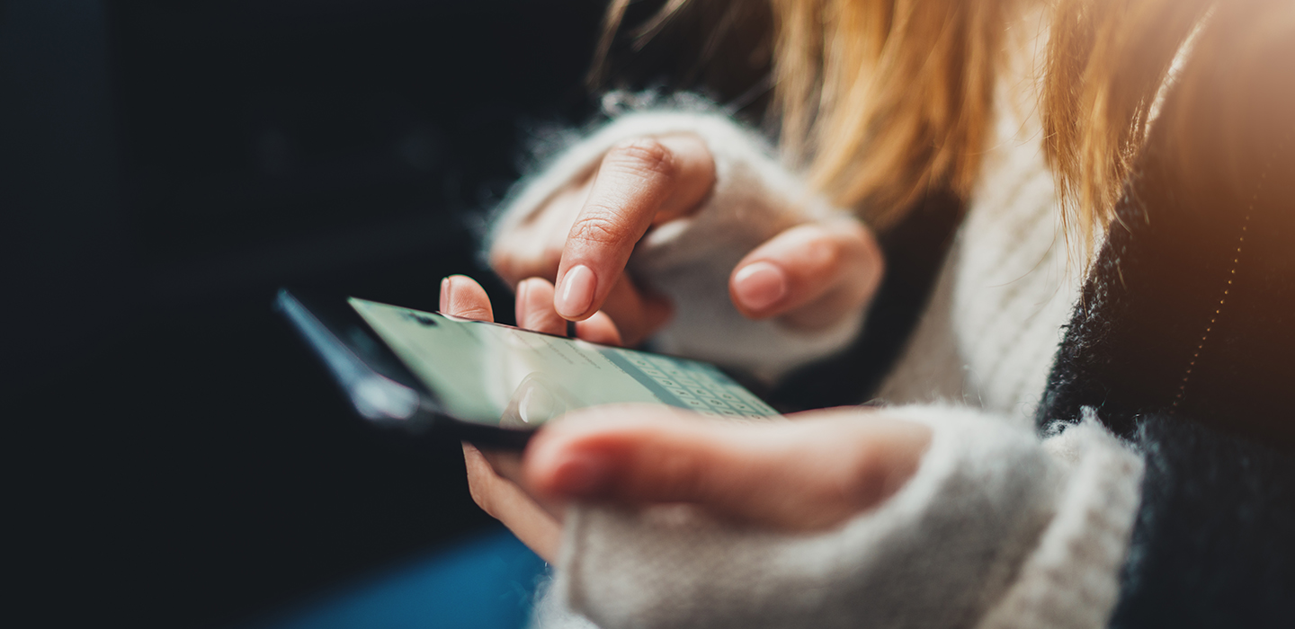A person touching the screen of their mobile phone