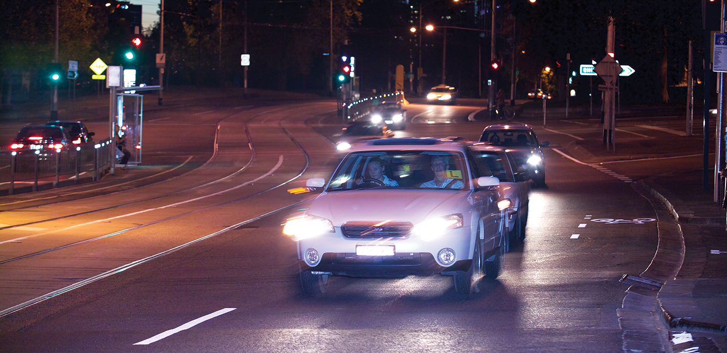 Cars driving on a main road at night